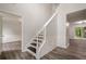 Inviting entryway with hardwood floors, paneled walls, and staircase leading to the second floor at 4959 Abbotts Glen, Acworth, GA 30101