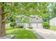 Gray two-story home featuring a two-car garage and well-manicured lawn with mature trees at 4959 Abbotts Glen, Acworth, GA 30101