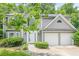 Charming gray two-story home featuring a two-car garage and meticulously maintained landscaping at 4959 Abbotts Glen, Acworth, GA 30101
