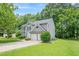 Well-maintained gray two-story home features an attached two-car garage, and a lush green lawn at 4959 Abbotts Glen, Acworth, GA 30101