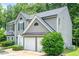 Gray two-story home with dark shutters, a two-car garage, and mature landscaping at 4959 Abbotts Glen, Acworth, GA 30101