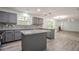 Well-lit kitchen with gray cabinets, granite counters, island, and backyard view at 4959 Abbotts Glen, Acworth, GA 30101