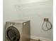Functional laundry area with modern washer-dryer and wire shelving for storage at 4959 Abbotts Glen, Acworth, GA 30101