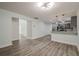 Open living space leading into kitchen with updated stainless steel appliances, pendant lighting and wood floors at 4959 Abbotts Glen, Acworth, GA 30101