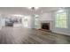 Bright living room features wood floors and fireplace, flowing to kitchen with an open layout at 4959 Abbotts Glen, Acworth, GA 30101