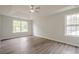 This main bedroom features a ceiling fan, hardwood floors, and large windows that provide natural light at 4959 Abbotts Glen, Acworth, GA 30101