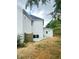 The home's backyard, with a small patio and lawn, offers a private outdoor space at 540 Langley Creek Dr, Loganville, GA 30052