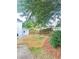 The backyard features terraced landscaping with mulched beds and a wooden retaining wall at 540 Langley Creek Dr, Loganville, GA 30052