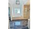 Modern bathroom with tub, glass shower, blue-toned tile flooring, and white textured tile walls at 540 Langley Creek Dr, Loganville, GA 30052