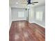 Spacious bedroom features hardwood floors, a ceiling fan, and a stylish sliding barn door at 540 Langley Creek Dr, Loganville, GA 30052