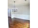 Dining room featuring hardwood floors, wainscoting, and a modern chandelier at 540 Langley Creek Dr, Loganville, GA 30052