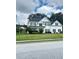 Charming two-story home featuring a manicured lawn and classic architectural details at 540 Langley Creek Dr, Loganville, GA 30052
