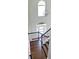 Bright foyer with high ceilings, modern chandelier, and a staircase with decorative wrought iron spindles at 540 Langley Creek Dr, Loganville, GA 30052