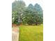 A well-manicured front yard adds curb appeal to the residence, featuring mature trees at 540 Langley Creek Dr, Loganville, GA 30052