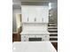 Kitchen area with an island, granite countertops, and a staircase at 540 Langley Creek Dr, Loganville, GA 30052