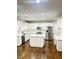 Bright kitchen with white cabinetry, stainless steel appliances, a kitchen island, and hardwood floors at 540 Langley Creek Dr, Loganville, GA 30052
