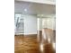 Bright, open-concept living space featuring hardwood floors, stairs, and freshly painted walls at 540 Langley Creek Dr, Loganville, GA 30052