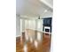 Spacious living room featuring gleaming hardwood floors, fireplace, and abundant natural light at 540 Langley Creek Dr, Loganville, GA 30052