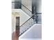Elegant staircase with dark wood banister, white risers, and beautiful wrought iron spindles at 540 Langley Creek Dr, Loganville, GA 30052