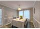 Charming dining room features modern light fixture, a table set for four, and stylish accent wall at 1202 Countryside Pl, Smyrna, GA 30080