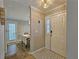 A welcoming entryway with tiled flooring, decorative light fixture, and view into the dining area at 1202 Countryside Pl, Smyrna, GA 30080