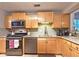 Charming kitchen featuring light wood cabinets, stainless steel appliances, and granite countertops at 1202 Countryside Pl, Smyrna, GA 30080