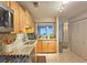 Bright kitchen with granite countertops, stainless appliances, and a pass-through window to another room at 1202 Countryside Pl, Smyrna, GA 30080