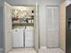 Convenient laundry area with washer, dryer, and shelving for storage solutions at 1202 Countryside Pl, Smyrna, GA 30080