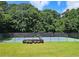 Outdoor tennis court with well-maintained lawn, surrounded by trees, provides recreational opportunities for residents at 1202 Countryside Pl, Smyrna, GA 30080