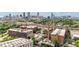 Wide aerial view of the community surrounded by trees with city skyline background at 170 Boulevard Se # E120, Atlanta, GA 30312