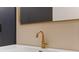 Close-up of a modern bathroom vanity with a gold faucet and a sleek white countertop at 170 Boulevard Se # E120, Atlanta, GA 30312