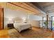 Cozy bedroom with wooden floors, exposed beams, and a comfortable bed at 170 Boulevard Se # E120, Atlanta, GA 30312