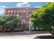 Front exterior of building with brick facade, lots of large windows, and green trees lining the entry at 170 Boulevard Se # E120, Atlanta, GA 30312