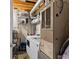 Functional laundry area with modern appliances, storage shelves, and exposed ceiling beams at 170 Boulevard Se # E120, Atlanta, GA 30312