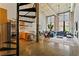 Spacious living room featuring an open kitchen, tall windows, and modern decor at 170 Boulevard Se # E120, Atlanta, GA 30312