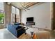 Bright, open living room with high ceilings, exposed brick, large windows, and stylish modern decor at 170 Boulevard Se # E120, Atlanta, GA 30312