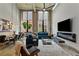 Bright living room with high ceilings, exposed brick, large windows, modern décor, and an open dining area at 170 Boulevard Se # E120, Atlanta, GA 30312