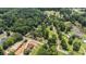 Aerial view featuring a large acreage, a pond, road access, and multiple structures at 677 Panola Rd, Ellenwood, GA 30294
