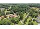 Expansive aerial view of the property showcasing its serene wooded surroundings and pond at 677 Panola Rd, Ellenwood, GA 30294