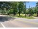 Scenic view of the property entrance with lush trees and a charming country setting at 677 Panola Rd, Ellenwood, GA 30294