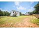 Large backyard featuring a covered patio with seating and a well-maintained lawn, surrounded by fencing at 93 Oakdale Way, Temple, GA 30179