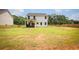 Spacious backyard features a covered patio, fenced perimeter, and ample green space for outdoor enjoyment at 93 Oakdale Way, Temple, GA 30179