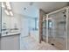 Light-filled bathroom features double vanity, soaking tub, and a frameless glass shower with tiled walls at 93 Oakdale Way, Temple, GA 30179