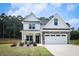 Charming two-story home featuring a well-manicured lawn, inviting front porch, and a two-car garage at 93 Oakdale Way, Temple, GA 30179
