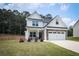 Charming two-story home featuring a well-manicured lawn, inviting front porch, and a two-car garage at 93 Oakdale Way, Temple, GA 30179