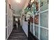 Stylish hallway showcasing sliding doors and sleek flooring, leading to other rooms in the house at 93 Oakdale Way, Temple, GA 30179