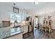 Bright kitchen with granite countertops, stainless steel appliances, and an adjacent dining area at 93 Oakdale Way, Temple, GA 30179