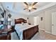 Spacious main bedroom boasts a tray ceiling, ceiling fan, and decorative wall art for added charm at 93 Oakdale Way, Temple, GA 30179
