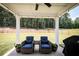 Covered patio offers a relaxing outdoor space with comfortable seating and views of the fenced backyard at 93 Oakdale Way, Temple, GA 30179