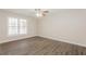 Bright bedroom with a large window, wood floors, and a ceiling fan at 4100 Summer Wood Dr, Snellville, GA 30039